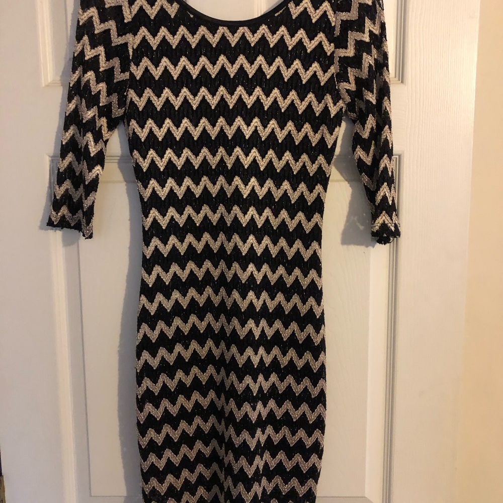 Black and gold short fitted dress with low back.